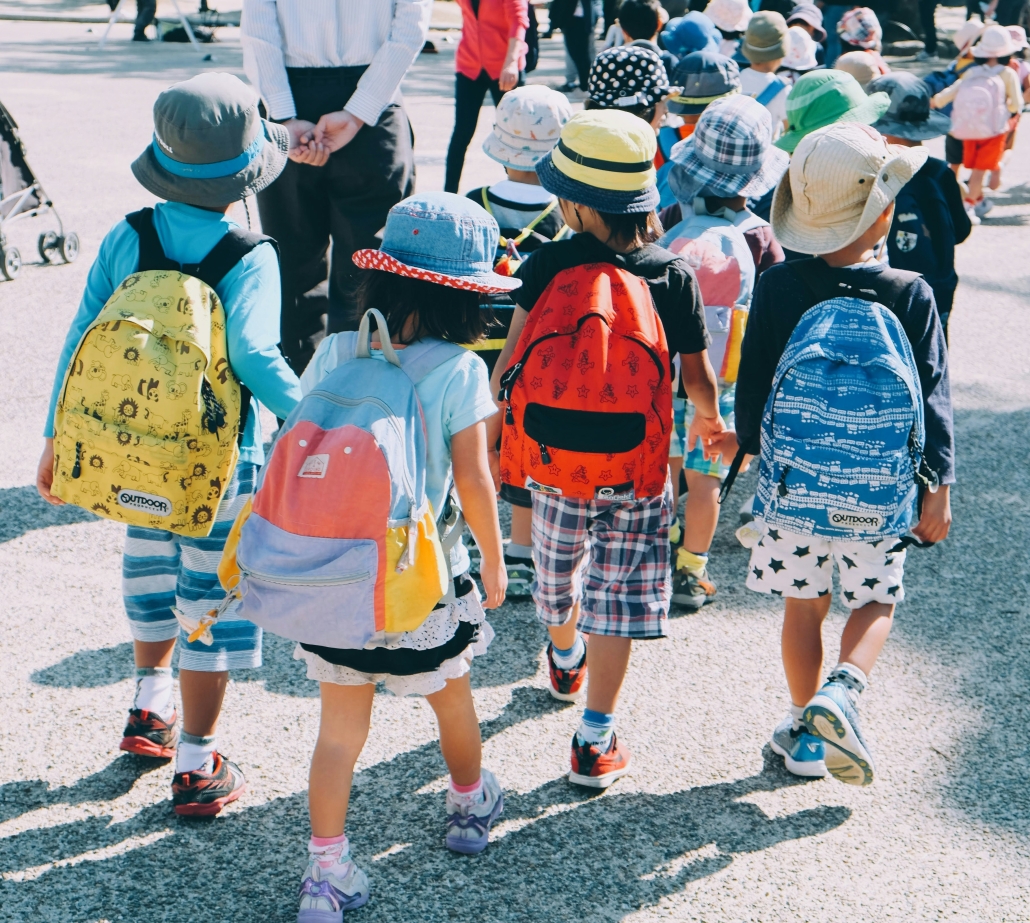 children walking down street from school